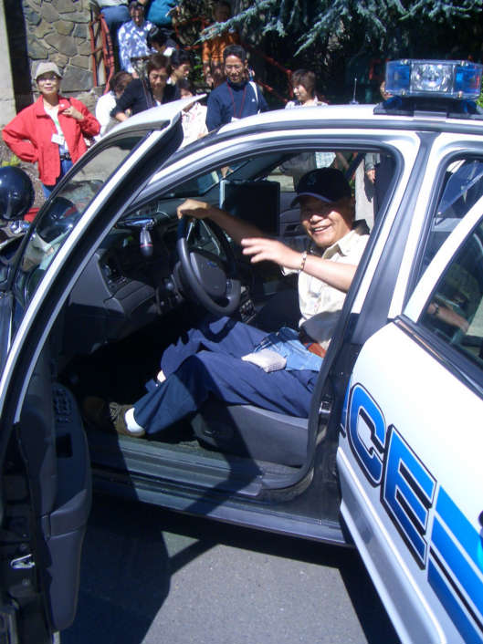 Tsutomu-san in a police car